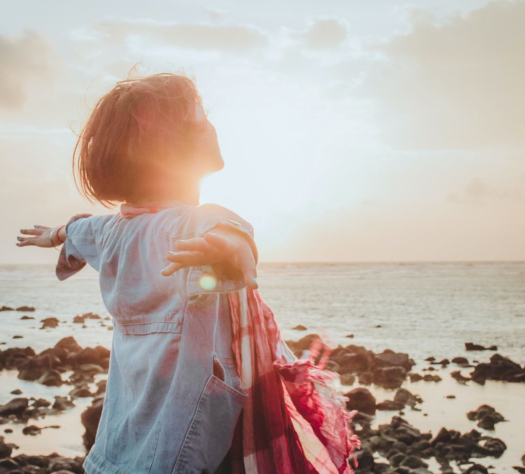 This image of a women with her arms open toward the sun is indicating her openness to life. It's positioned as the cover photo because it represents the message of the Reclaim Her blog post.