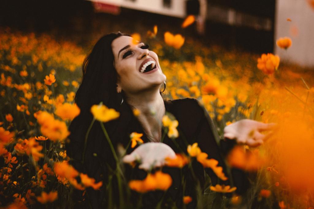 From fear to freedom.. This image is of a joyful woman in a field of orange flowers. It represents a woman who is filled with life & operating in freedom. We want the women reading our Reclaim Her blog post to see themselves in it.